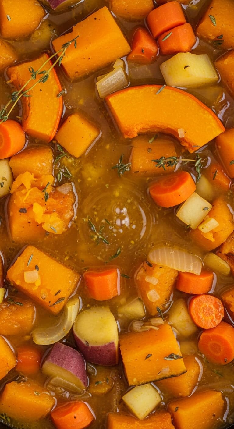 Cooked tender pumpkin and vegetables in slow cooker before blending