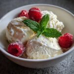 Keto cottage cheese ice cream in bowl with mint and berries